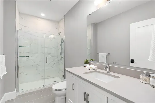 a bathroom with a sink toilet and shower