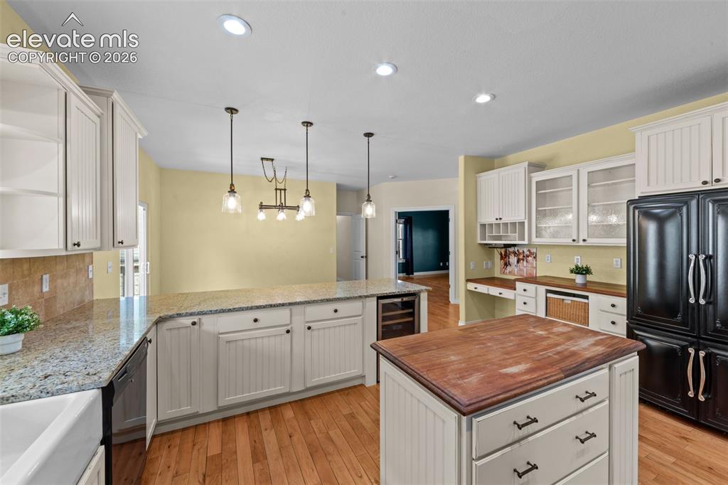 16540 Mesquite Road Peyton, CO 80831 - Photo 10 of 50 a kitchen with stainless steel appliances granite countertop a sink stove and refrigerator