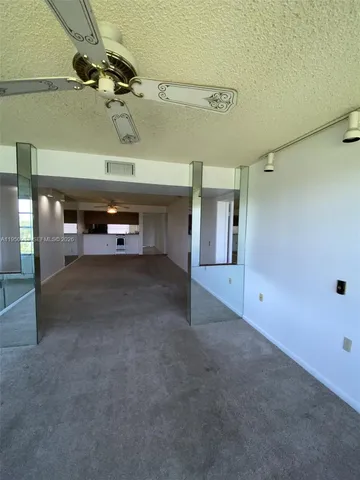 a view of a livingroom with furniture and a ceiling fan