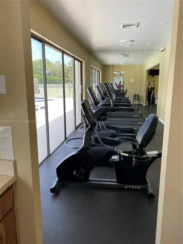 a room with gym equipment and a large window