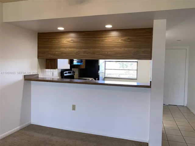 a close view of kitchen cabinet with microwave