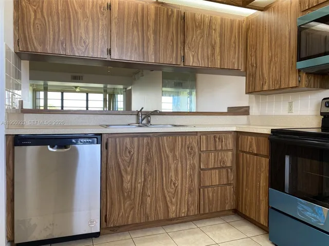 a kitchen with stainless steel appliances granite countertop a sink and a microwave