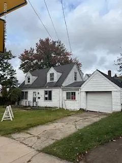 a front view of a house with a garden and plants