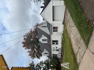 a front view of a house with a garden and plants