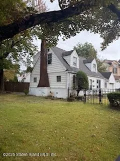 a front view of a house with a garden and sitting area