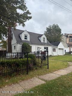 135 Todt Hill Road Staten Island, NY 10314 - Photo 3 of 4 a front view of a house with a yard table and chairs