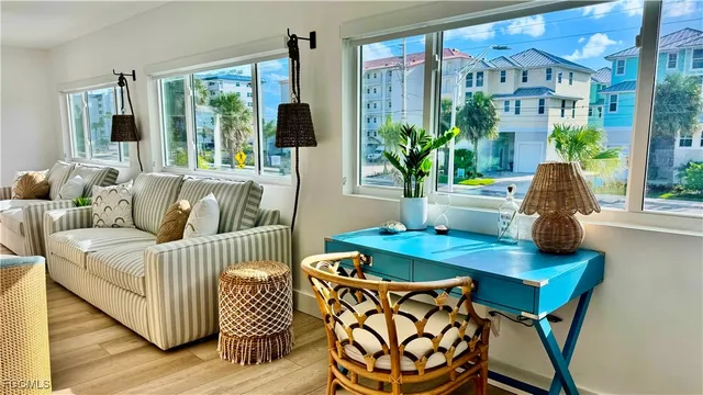 a living room with furniture and a floor to ceiling window