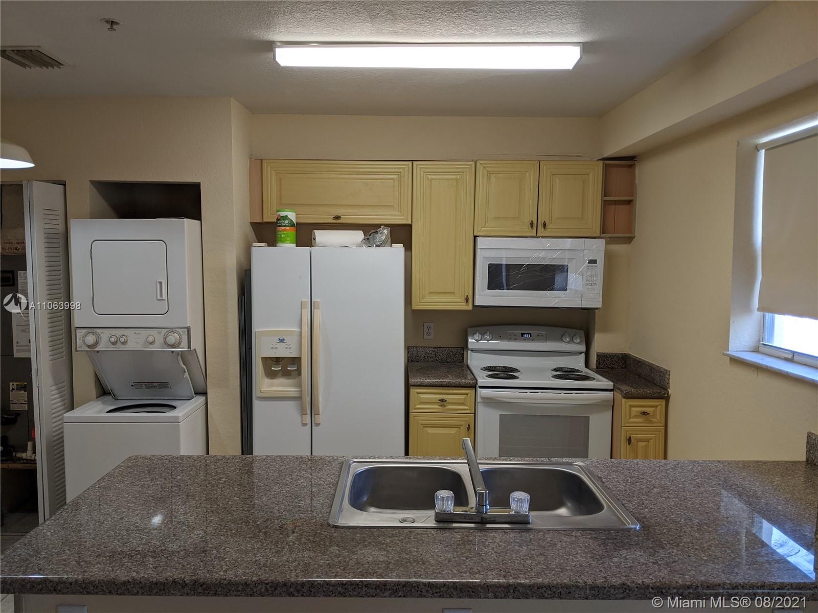 520 Southwest 5th Street, Unit 203 Miami, FL 33130 - Photo 4 of 51 a kitchen with a refrigerator sink and stove