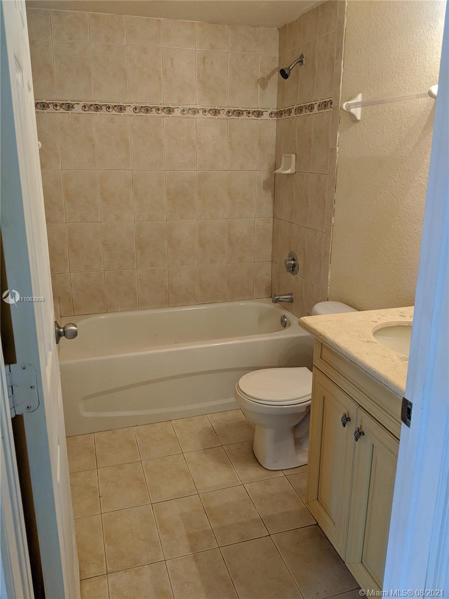 520 Southwest 5th Street, Unit 203 Miami, FL 33130 - Photo 7 of 51 a bathroom with a toilet sink and shower
