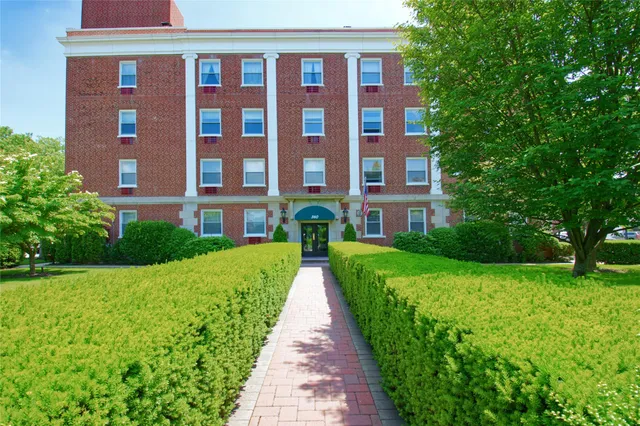 a view of a brick building next to a big yard