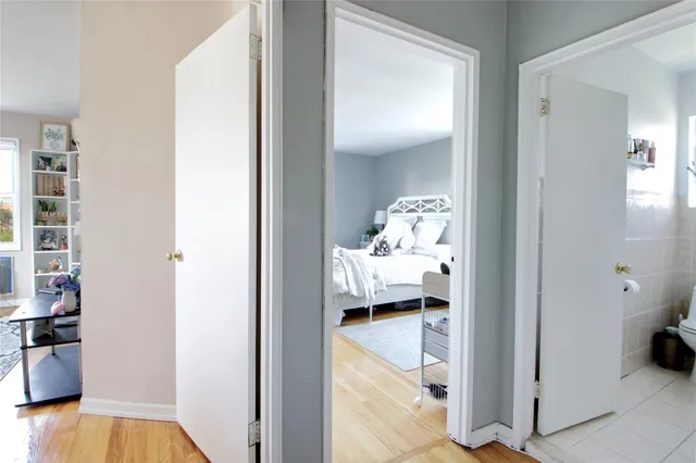 a view of living room and bedroom with wooden floor