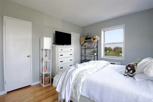 a bedroom with a bed and a television