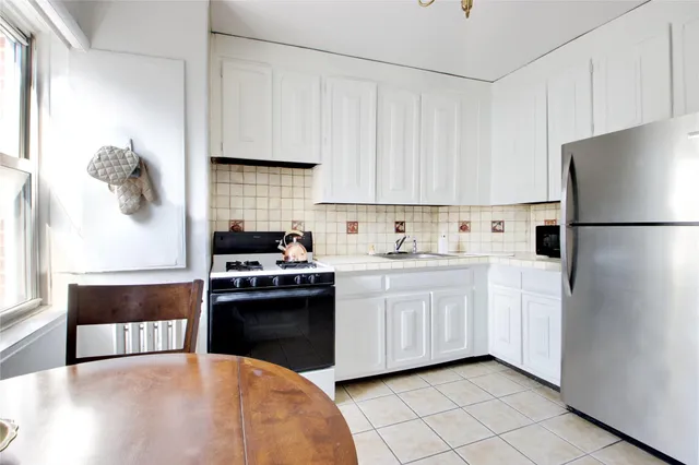 a kitchen with cabinets and stainless steel appliances