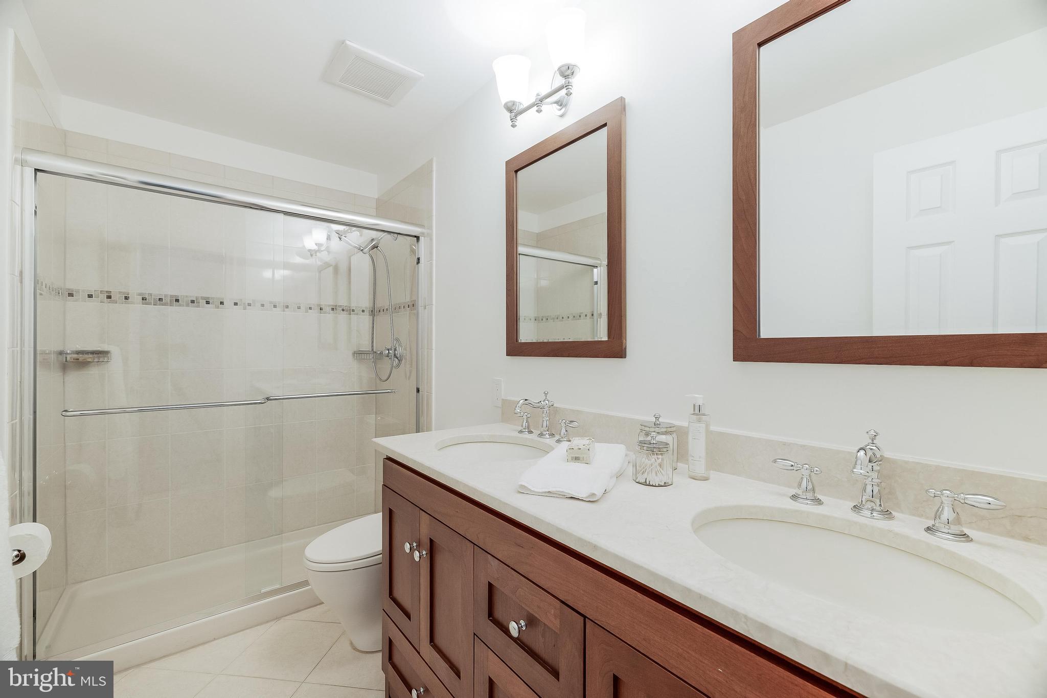 1205 Suffield Drive McLean, VA 22101 - Photo 49 of 76 a bathroom with a double vanity sink toilet and shower