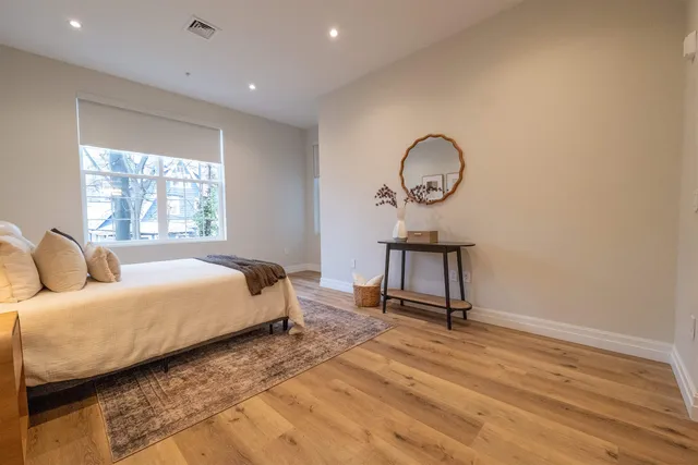 a bed room with a bed window and a table