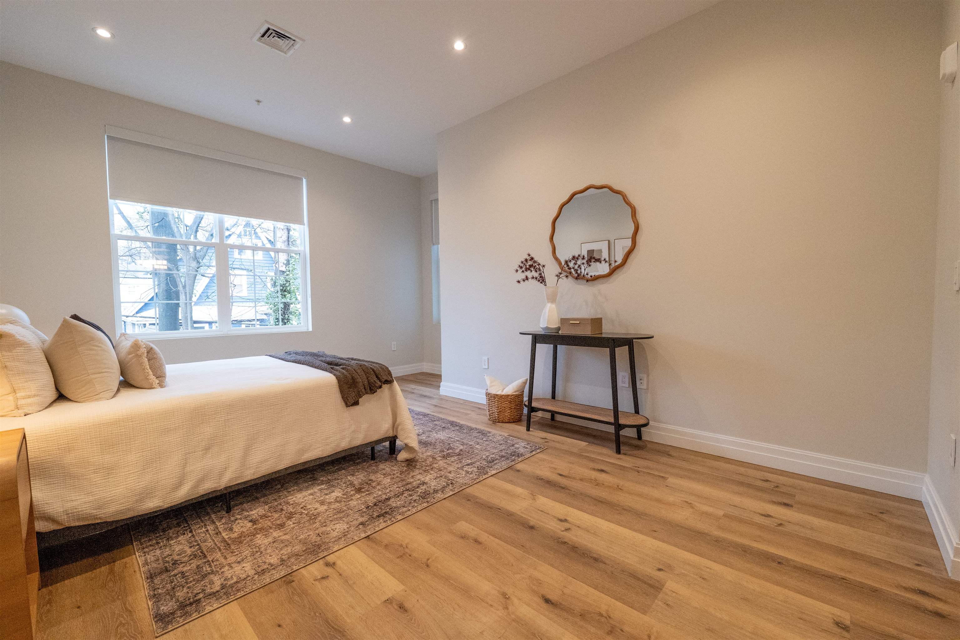 1722 Springfield Avenue, Unit 404 Maplewood, NJ 07040 - Photo 8 of 30 a bed room with a bed window and a table