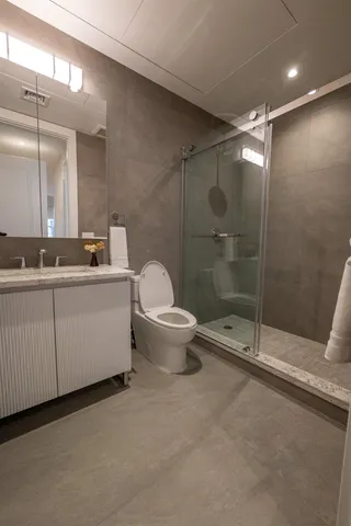 a bathroom with a toilet sink and shower