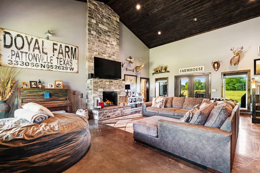 962 County Road Pattonville, TX 75468 - Photo 9 of 37 a living room with furniture a fireplace and a flat screen tv