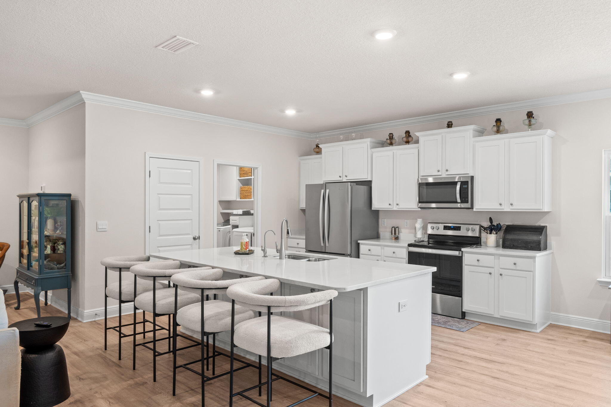 44 Secluded Circle Freeport, FL 32439 - Photo 19 of 43 a kitchen with stainless steel appliances a stove top oven a refrigerator a sink and a dining table with wooden floor
