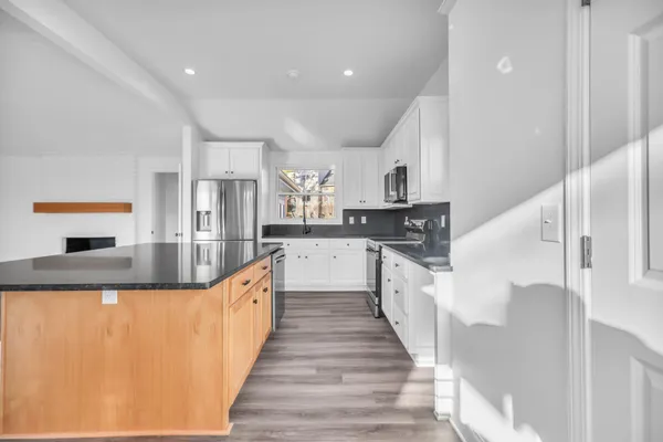a view of a room with wooden floor closet and windows