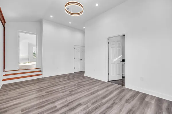 a bathroom with a granite countertop sink a toilet and a mirror