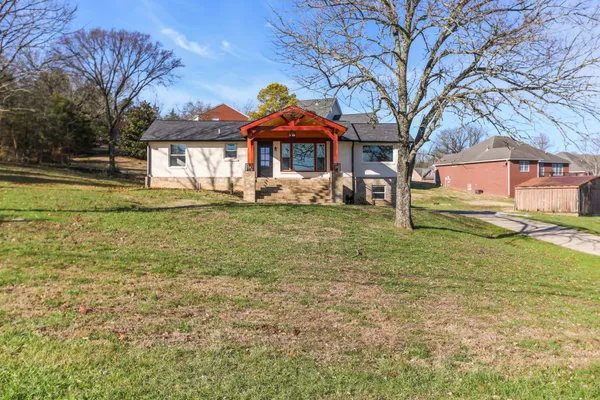 a front view of a house with a yard