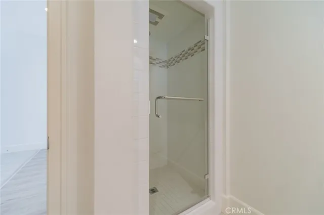 a bathroom with a glass shower door