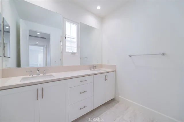 a bathroom with 2 sink and a mirror