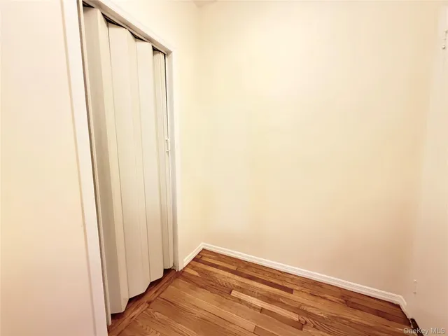 a view of a small space with wooden floor