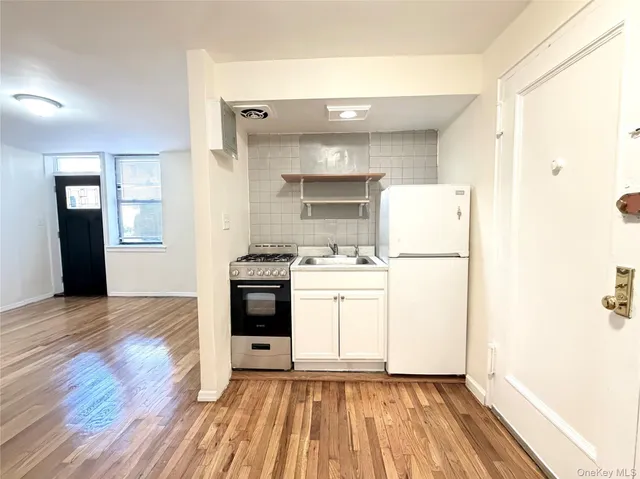 a view of kitchen and utility room with closet wooden floor