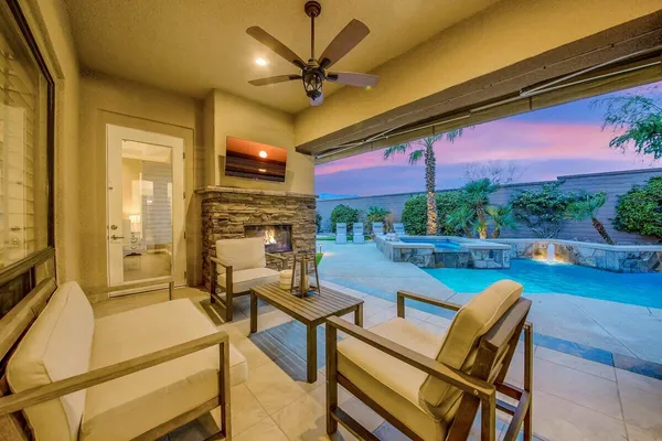 a view of a patio with a table and chairs