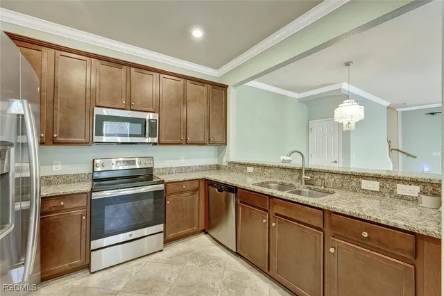 a kitchen with stainless steel appliances granite countertop a sink stove and microwave