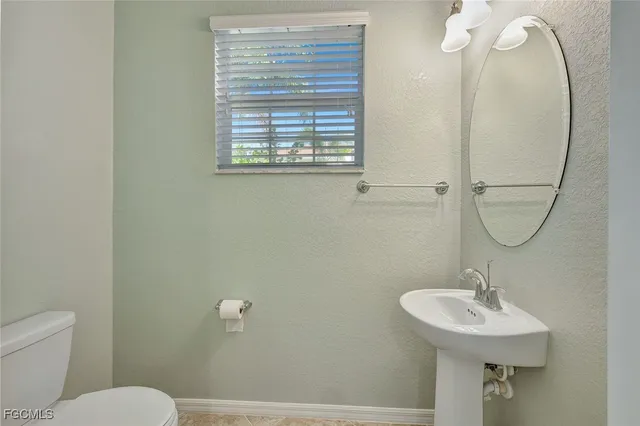 an empty room with windows and ceiling fan