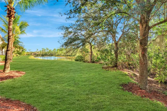 a view of a lake with houses in the back