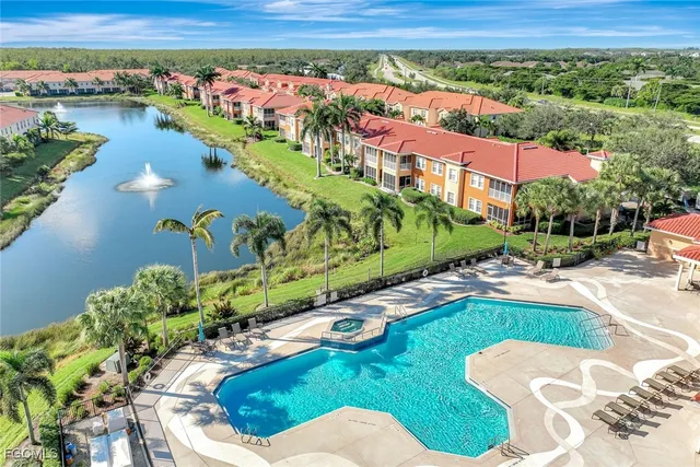 an aerial view of residential houses with outdoor space and ocean view