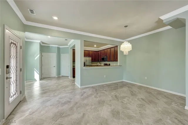 an empty room with a kitchen and a sink