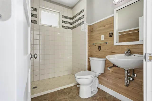 a bathroom with a sink toilet and shower