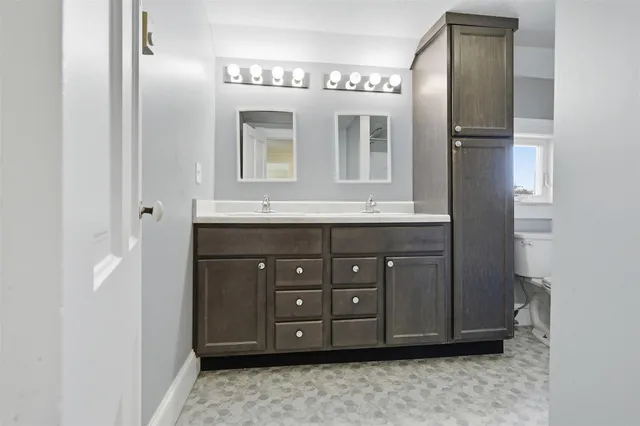 a bathroom with a sink vanity and mirror