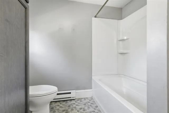 a bathroom with a bathtub and a toilet