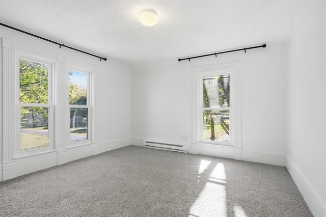 an empty room with windows and entrance