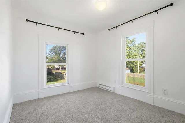 an empty room with windows and closet