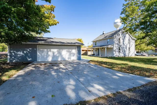 a view of a house with a yard and garage