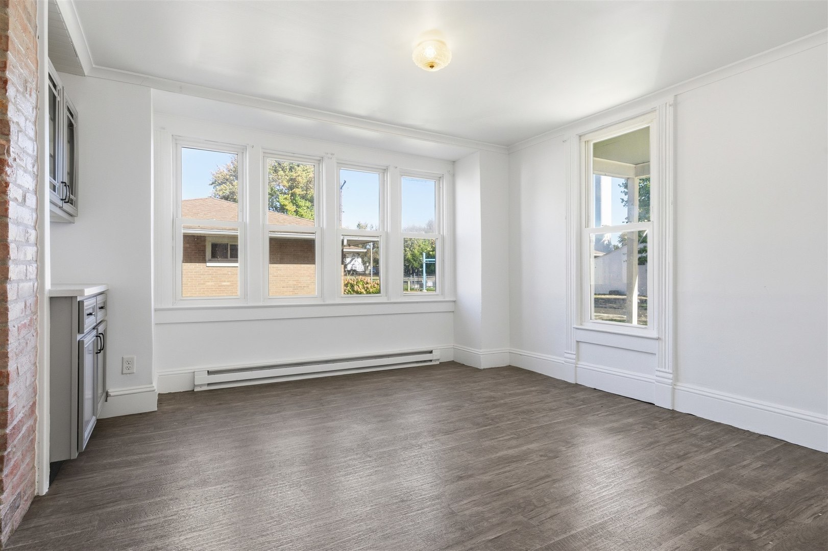 305 South Perry Street Carlock, IL 61725 - Photo 5 of 30 a view of an empty room with wooden floor and a window