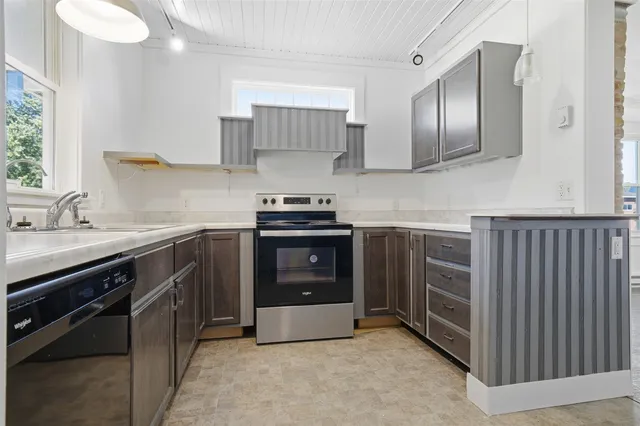 a kitchen with stainless steel appliances granite countertop a stove sink and cabinets