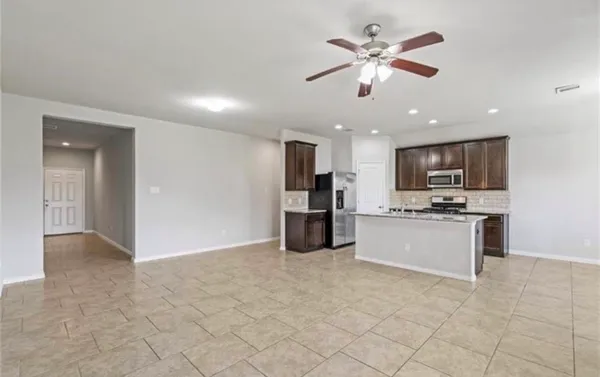 a view of an empty room with a kitchen