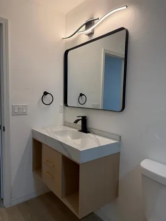 a bathroom with a sink a vanity and a mirror