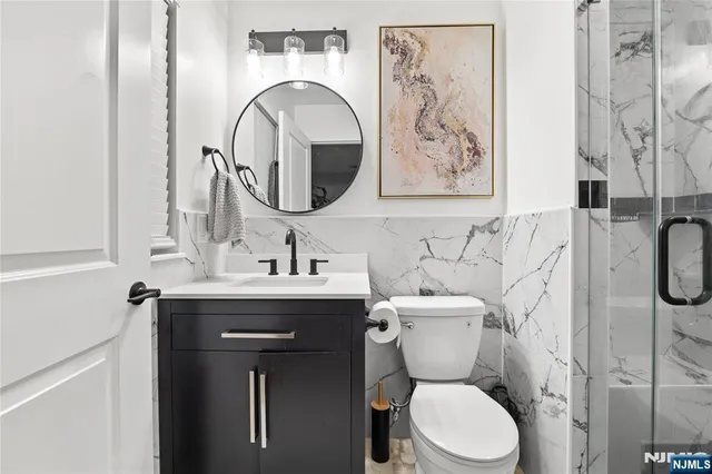 a bathroom with a sink toilet and mirror