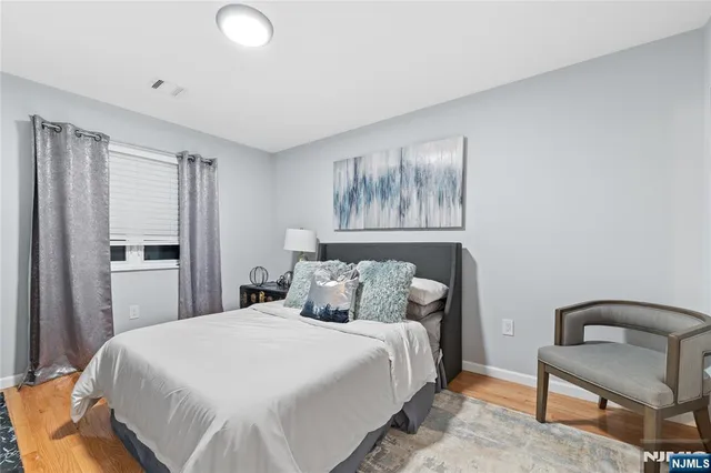 a bedroom with a bed and a tv