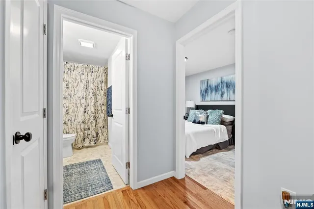 a view of entryway and hall with wooden floor