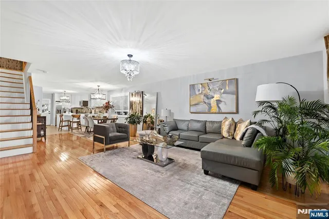a living room with furniture and view of kitchen